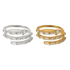 Two sets of stacked rings, one silver and one gold, on a white background.