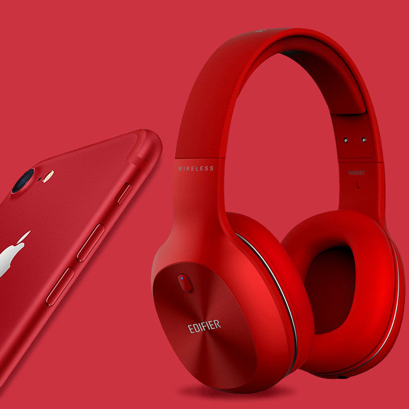 Red Edifier headphones and phone on a red background