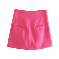 A bright pink high-waisted A-line mini skirt with two front welt pockets, shown flat against a plain white background.