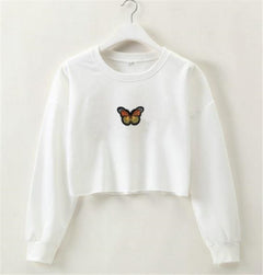 White sweatshirt with a butterfly design on a hanger against a white background