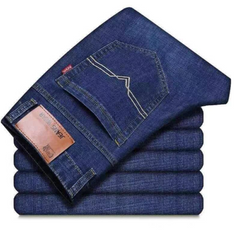 A stack of folded dark blue denim jeans with the top pair laid flat to show the back pocket, contrast stitching, and a brown leather brand patch. The brand name 'JEANS MAN' is visible on the patch.