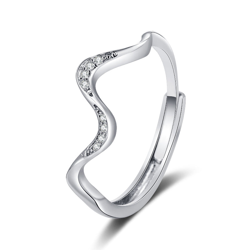 Silver ring with wavy design and small diamonds on a white background
