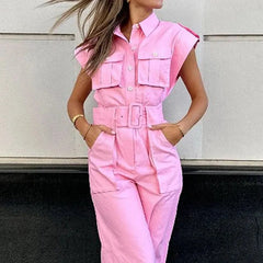 Person wearing a pink jumpsuit with a neutral background