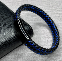 Black and blue braided bracelet on a textured surface