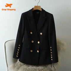 Black double-breasted jacket with gold buttons on a hanger against a white background
