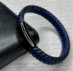 Black and blue braided bracelet on a textured surface