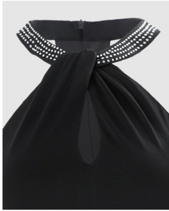 Black dress with a decorative collar on a light gray background