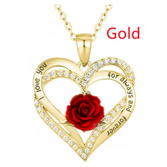 Gold heart-shaped necklace with a red rose and engraved text on a white background