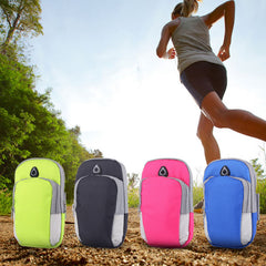 Four colorful running arm bags on the ground with a person running in the background.