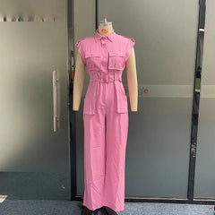 Mannequin wearing a pink jumpsuit in front of a glass door.