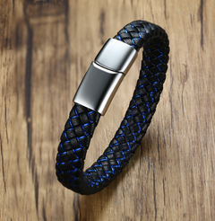 Black and blue braided bracelet with a silver clasp on a wooden surface