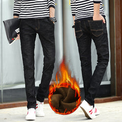 Person wearing black jeans with a fiery effect on one foot, standing against a neutral background.