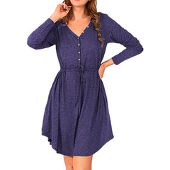 Woman wearing a blue dress with long sleeves on a white background